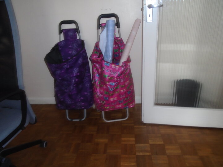 Photo of shopping bags by a door