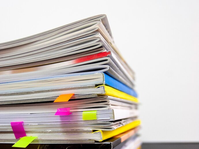 Stack of journals and magazines with some page tabs sticking out