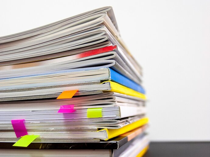 Stack of journals and magazines with some page tabs sticking out