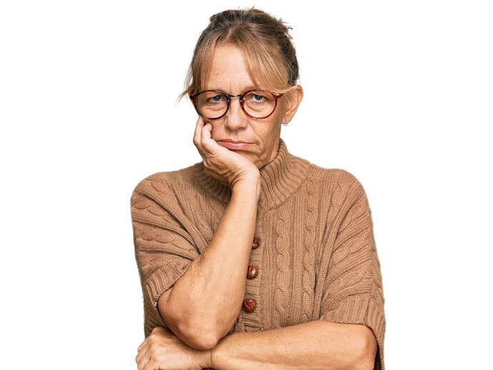 Photo of a woman with her head resting in her hand, looking bored