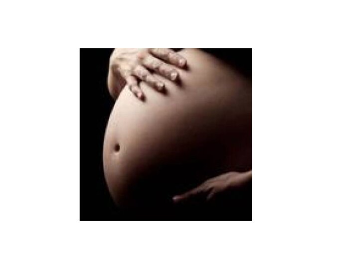 photo of a stomach of a heavily pregnant woman