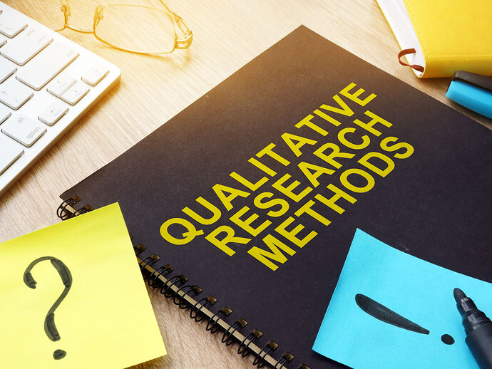 Picture of a notebook with "qualitative research method" written on the cover