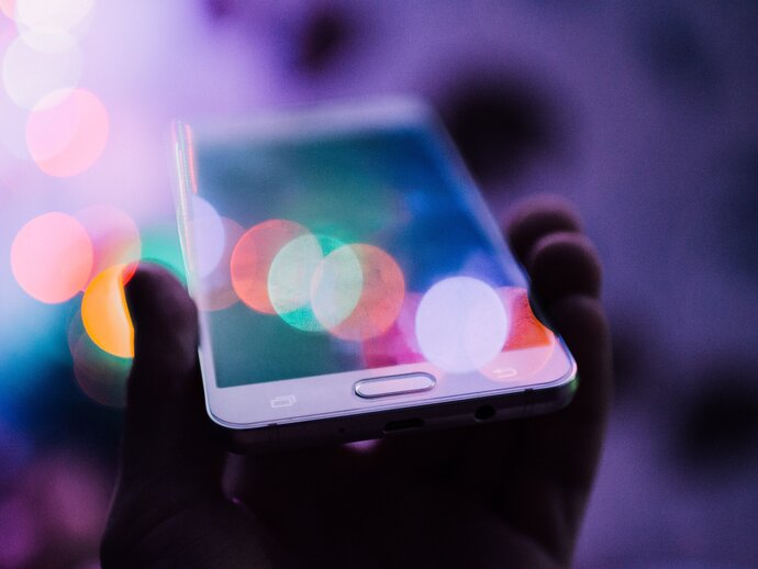 Photo of a hand holding a mobile phone