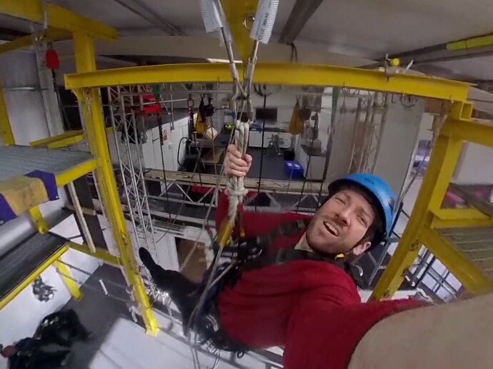 Photo of Andrew installing a camera for his research