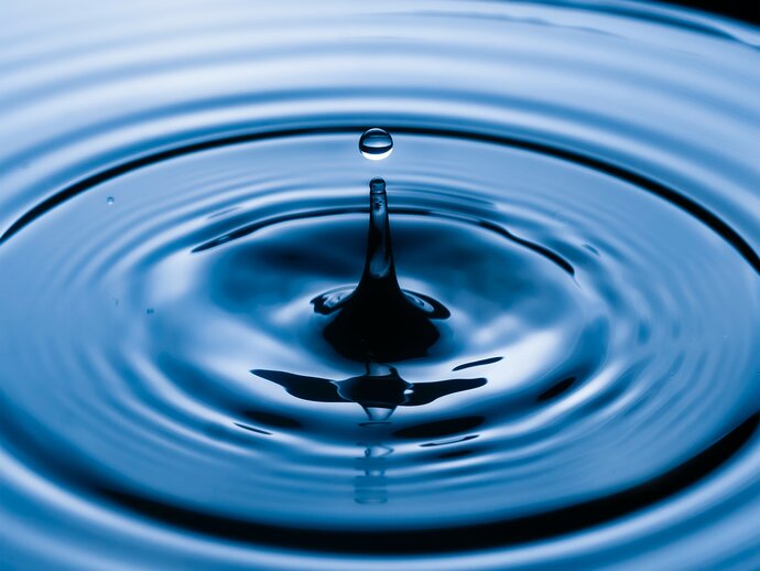 Splash and ripples in blue water