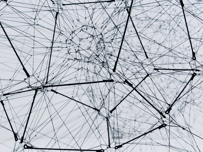 low-angle image of a metal structure consisting of connecting wires and rods