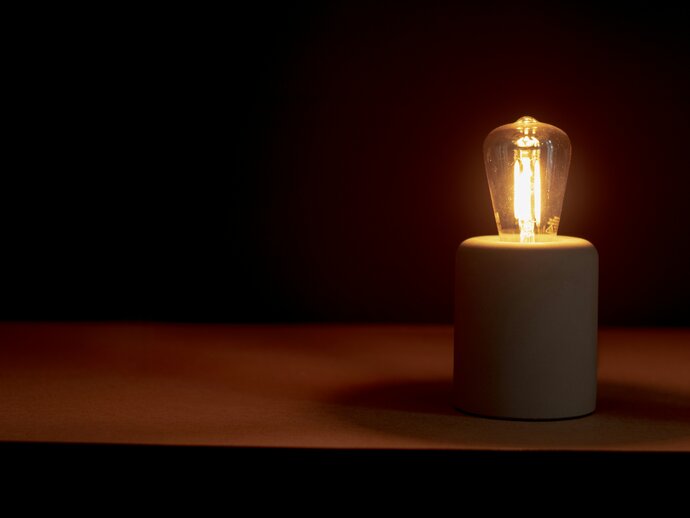 a lightbulb lit up against a dark background