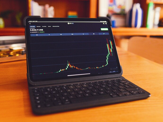 Tablet showing a graph of increasing profit on its screen.