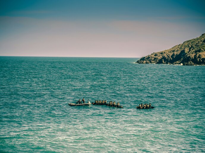 A zoomed out image of crowded boats on the ocean