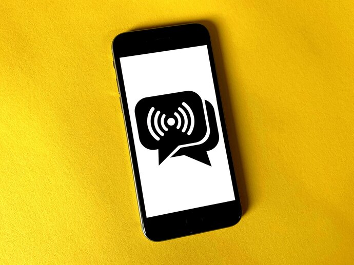 phone with speech bubbles on a yellow background