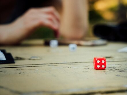 Ward-based activities can be perceived as a way to structure service users’ day or an opportunity to engage with something joyful or to reduce boredom. They differ from therapeutic engagement and activities offered by occupational therapists or psychologists. Photo of a tabletop where dice games are being played