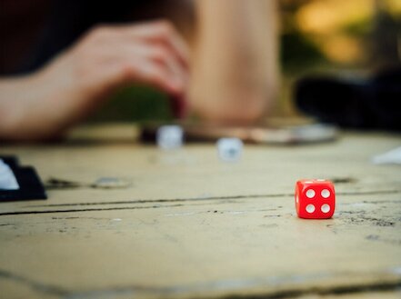 Photo of a tabletop where dice games are being played