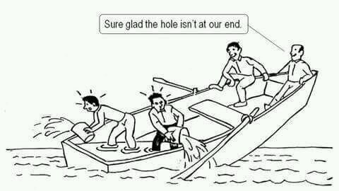Picture shows a cartoon boat with four people in it, sinking at one end and the two people at the other end saying "sure glad the hole isn't at our end"
