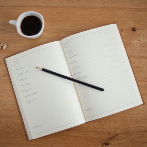 Photo by Marissa Grootes on Unsplash An open diary on a desk with a cup of coffee and a pencil