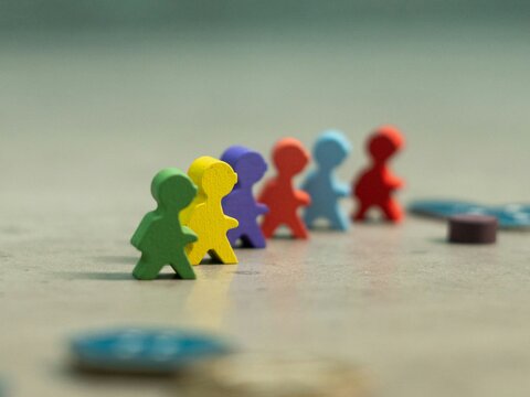 wooden figurines as counters on a game board