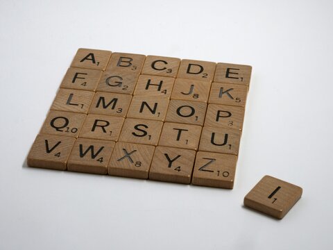 Wooden scrabble blocks for the whole alphabet placed in a square