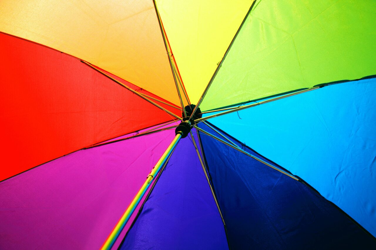 A rainbow umbrella photographed from below