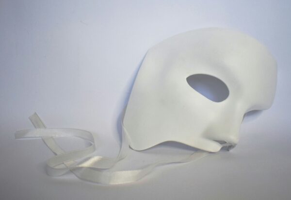White theatrical mask on a pale background