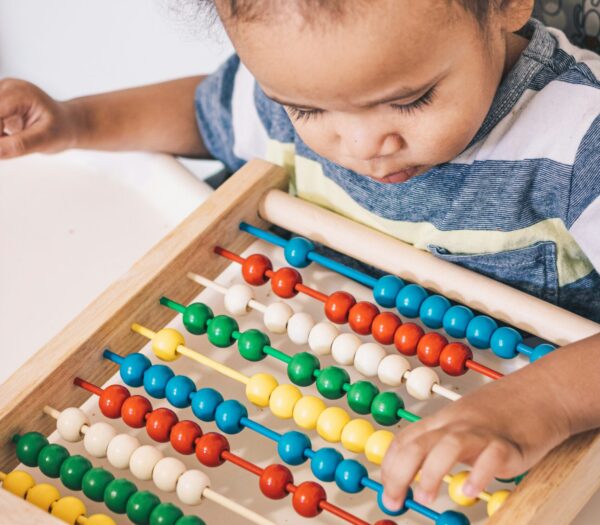 Small child playing with an abacus