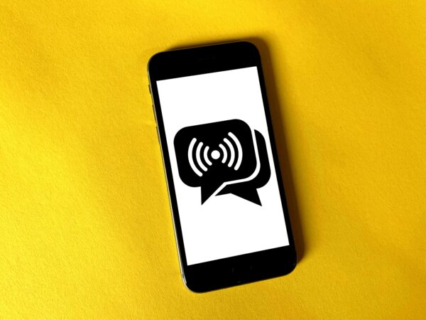 phone with speech bubbles on a yellow background