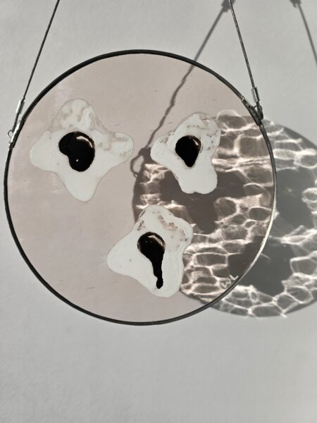 Glass painting casting dramatic shadows on the wall behind