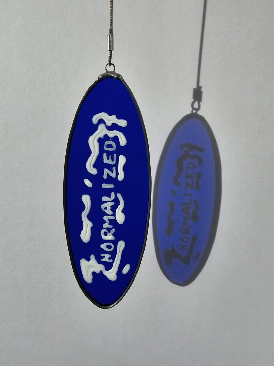 Painted glass with the text "normalized"