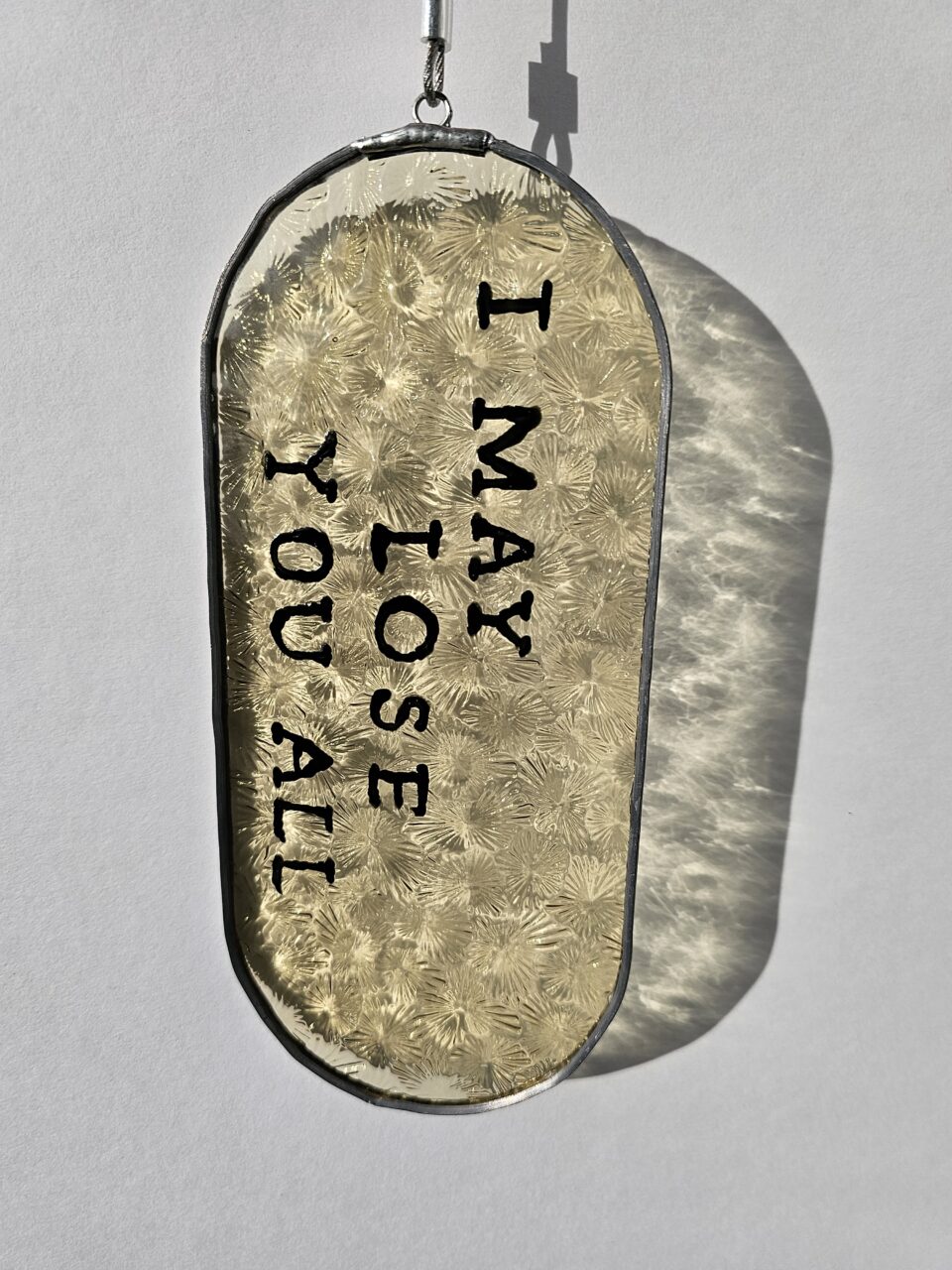 Painted glass with the text "I may lose you all"