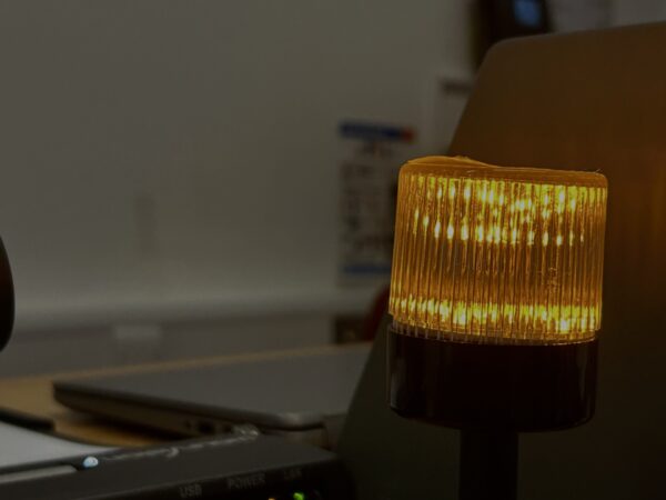 A light at the front of a classroom glowing orange