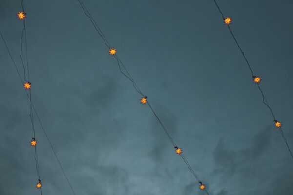 Star shaped fairy lights against a cloudy night sky background
