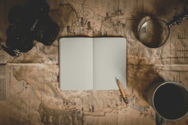A notebook lying open with a pencil on the blank page