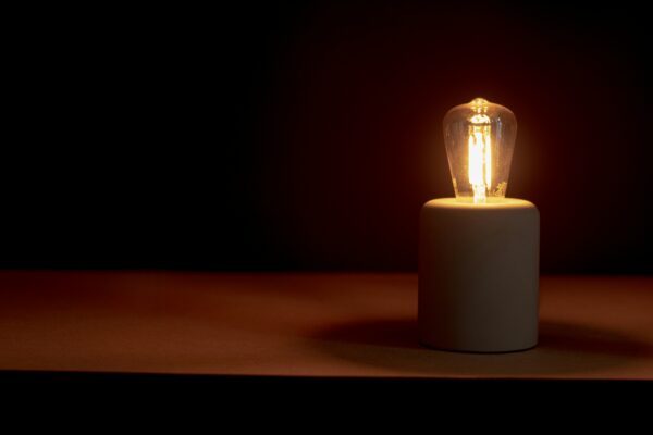 a lightbulb lit up against a dark background