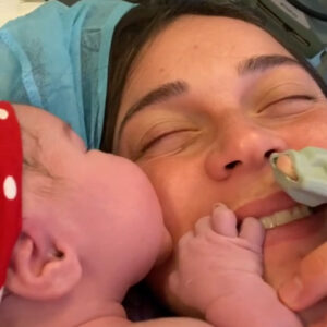 mother and newborn baby cuddling